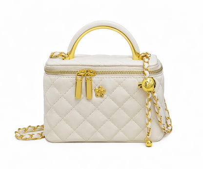 White quilted handbag with gold accents on a white background